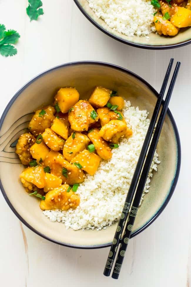 Whole 30 Mango Chicken with Coconut Cauliflower Rice - This paleo mango chicken is served over coconut cauliflower rice for a quick, easy and healthy spin on take-out that is ready in 30 mins! Recipe has a vegan option too! | Foodfaithfitness.com | @FoodFaithFit