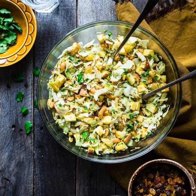 Curry Cashew Shredded Cabbage Salad with Apples - A sugar and gluten free healthy salad that is mixed with a creamy curry dressing and crunchy cashews! A healthy, paleo and whole30 side dish that everyone will love! | Foodfaithfitness.com | @FoodFaithFit